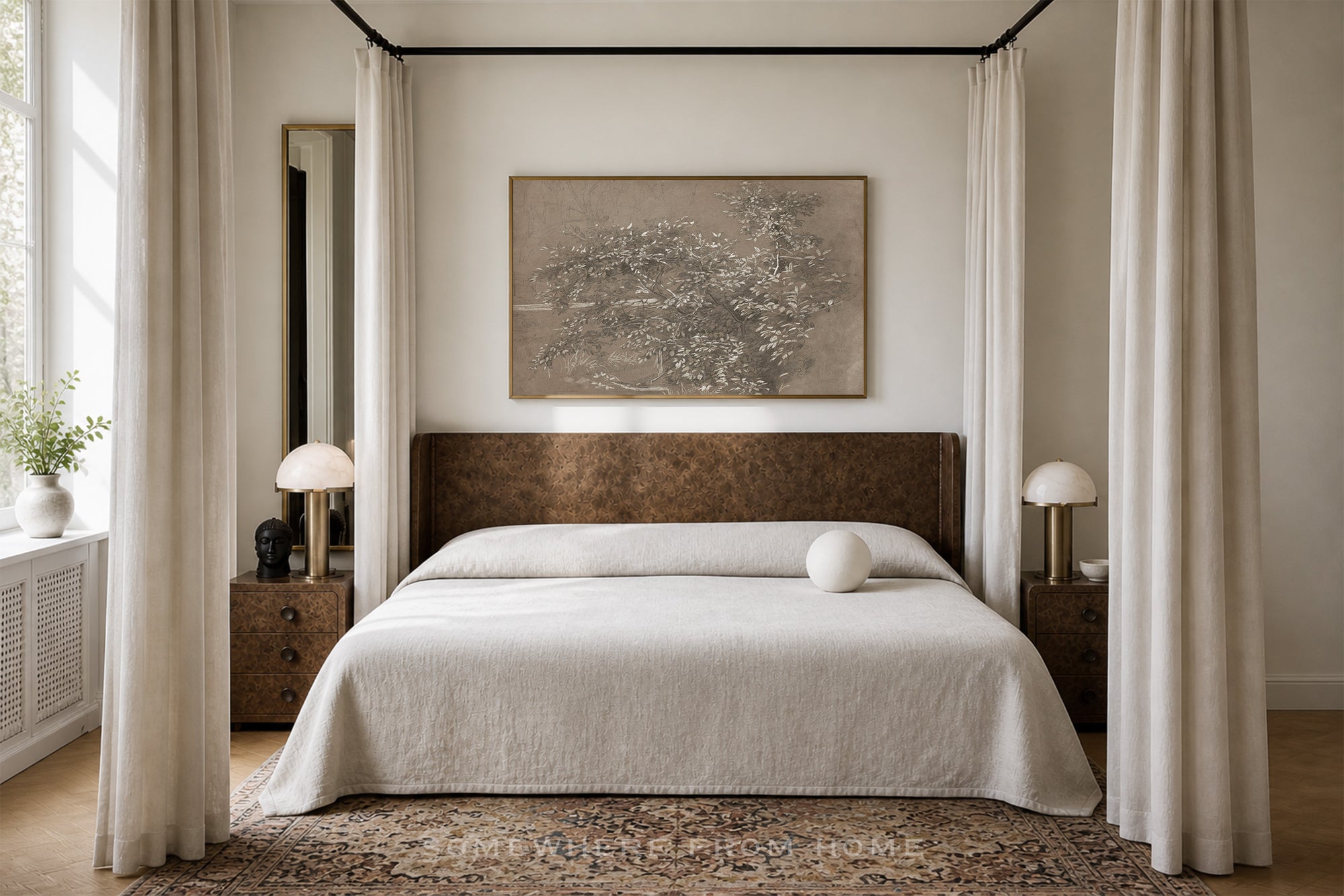 A styled bedroom featuring a four-poster-style bed with a dark brown upholstered headboard, dressed in white bedding. The room is decorated with cream-colored curtains, wooden nightstands with white table lamps, a patterned area rug, and a large framed abstract painting on the wall above the bed.