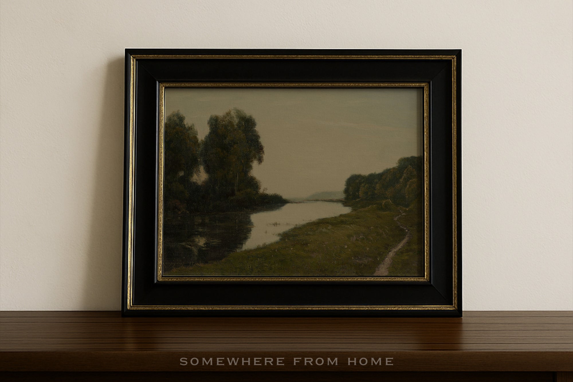 Framed landscape painting on a wooden shelf with 'Somewhere from Home' text.