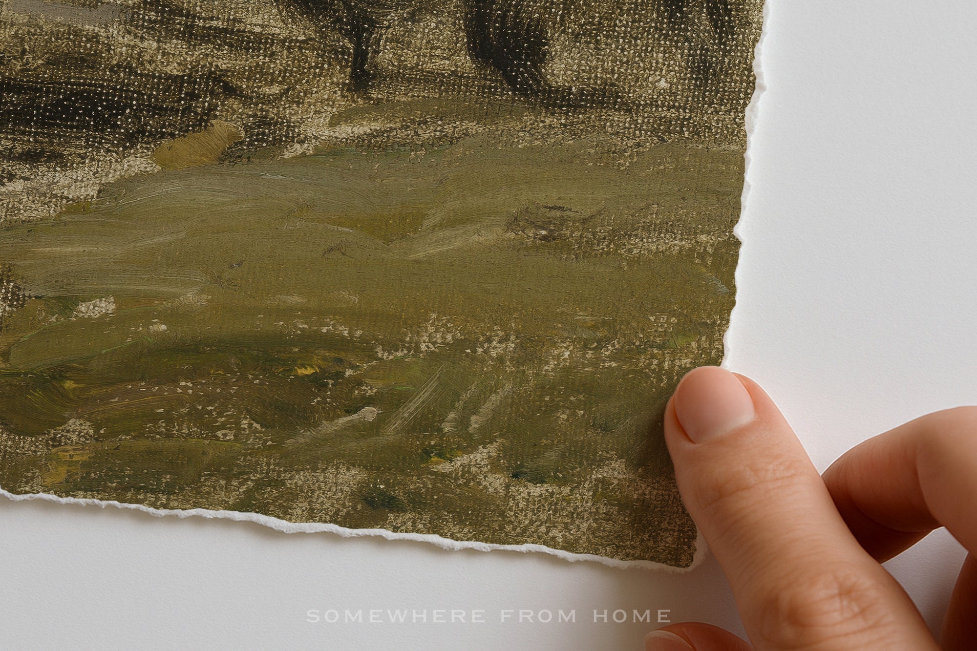 A close-up of a textured oil painting showing brushstrokes of olive green, brown, and black, held by a hand along its torn paper edge against a white background.