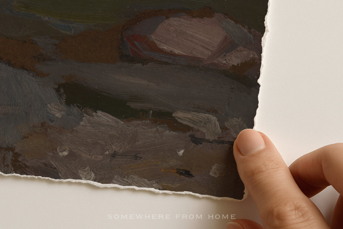 A close-up of a hand holding the edge of a textured, hand-painted art print or canvas with a torn paper look, showing various earthy brushstrokes of brown, gray, and green. A faint watermark at the bottom reads 'SOMEWHERE FROM HOME'.