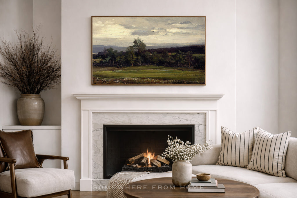 Living room with a fireplace, sofa, and moody green landscape painting of a golf course fairway in a thin gold frame- somewhere from home