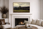 Living room with a fireplace, sofa, and moody green landscape painting of a golf course fairway in a thin gold frame- somewhere from home