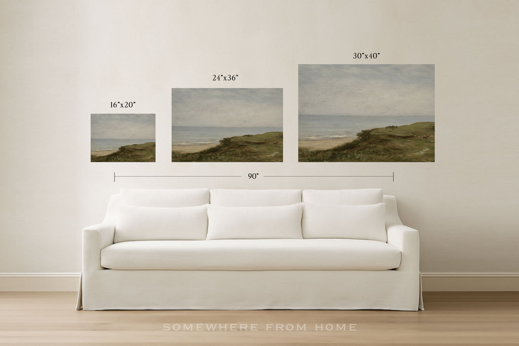 Three framed wall art prints showing coastal dune landscapes in different sizes, displayed above a white sofa in a bright room. Black text above each print indicates dimensions, and a larger 90" width measurement is shown across the set.