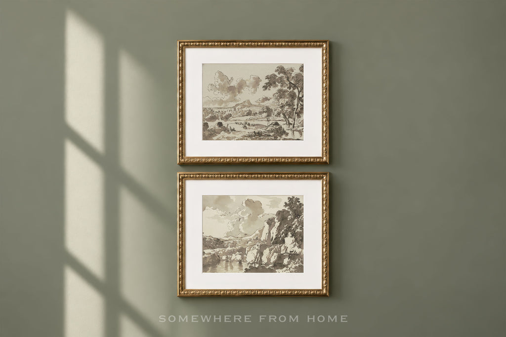 Two framed sepia landscape art prints with ornate gold frames and white mats, hanging vertically on a muted sage green wall with soft window shadow cast across it. Text at the bottom reads 'SOMEWHERE FROM HOME'.