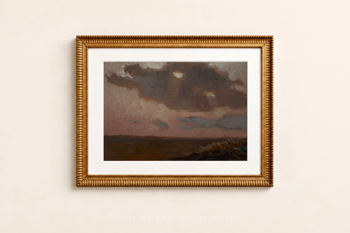 A framed landscape painting featuring a dark, moody sky over a flat horizon, presented in a textured gold frame with a white mat against a light beige wall.
