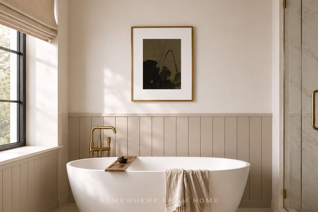 A modern bathroom interior with a freestanding white bathtub, a gold faucet, a framed abstract print on the wall, and a window with a beige blind. The text 'SOMETHING REMEMBER HOME' appears at the bottom.