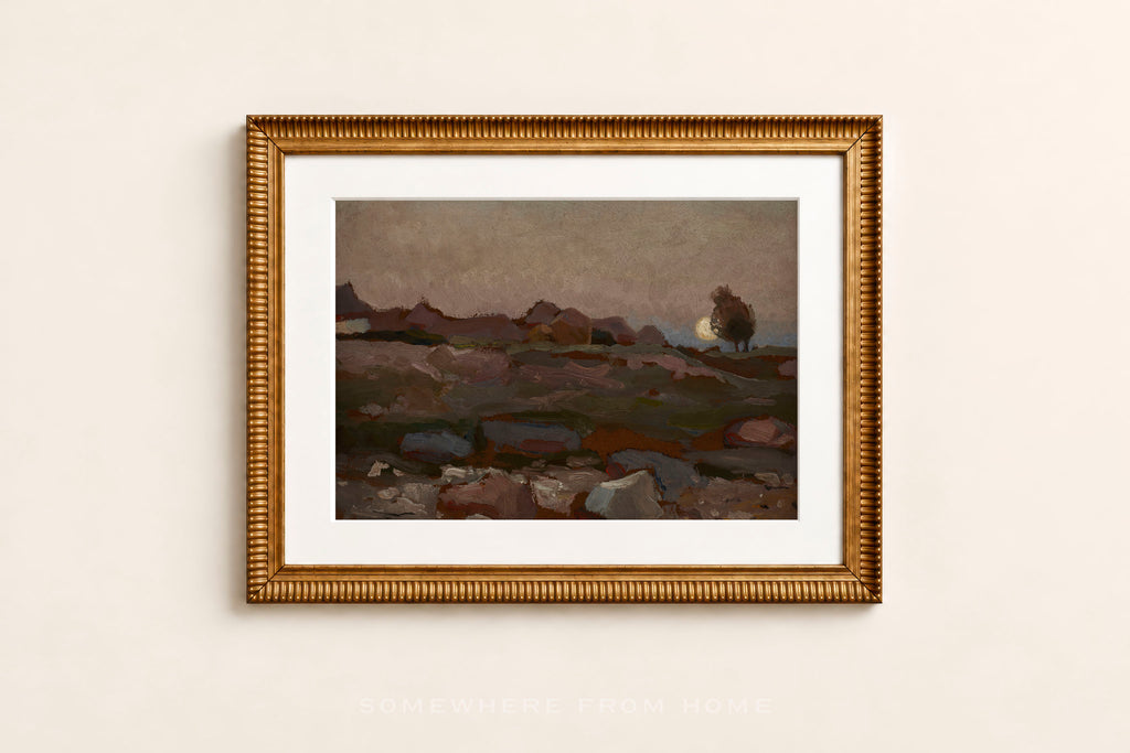 A framed landscape art print featuring a moody, painterly scene with a lone tree and distant hills, enclosed in a textured gold frame with a white mat, mounted on a light beige wall.