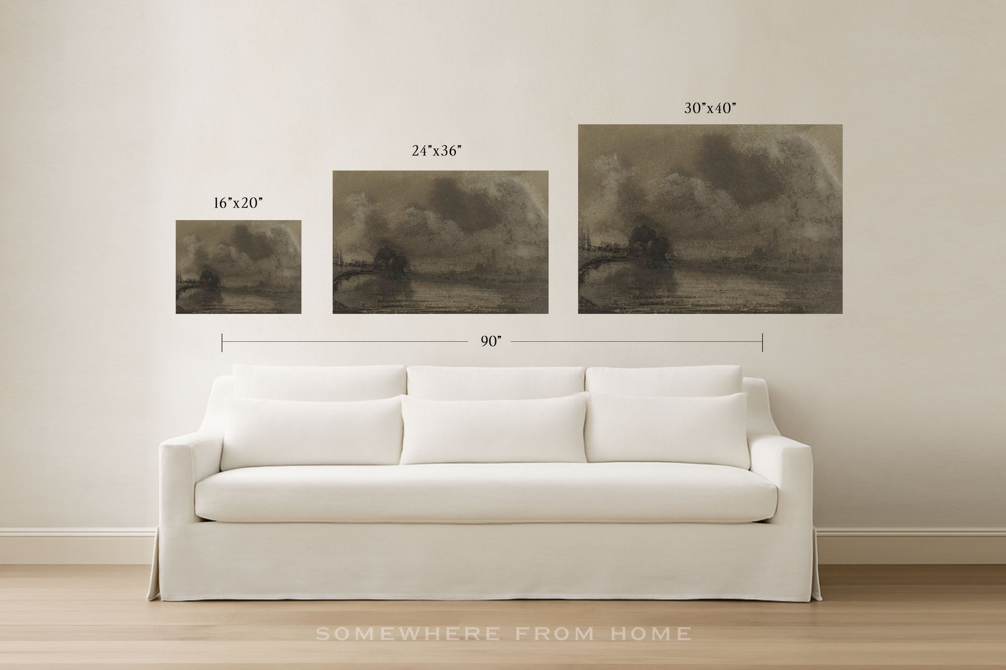 Three framed-style wall art prints showing dark moody landscape scenes are displayed above a white sofa in a bright room. Measurement labels and arrows indicate the width of each print and the combined width of 90 inches.