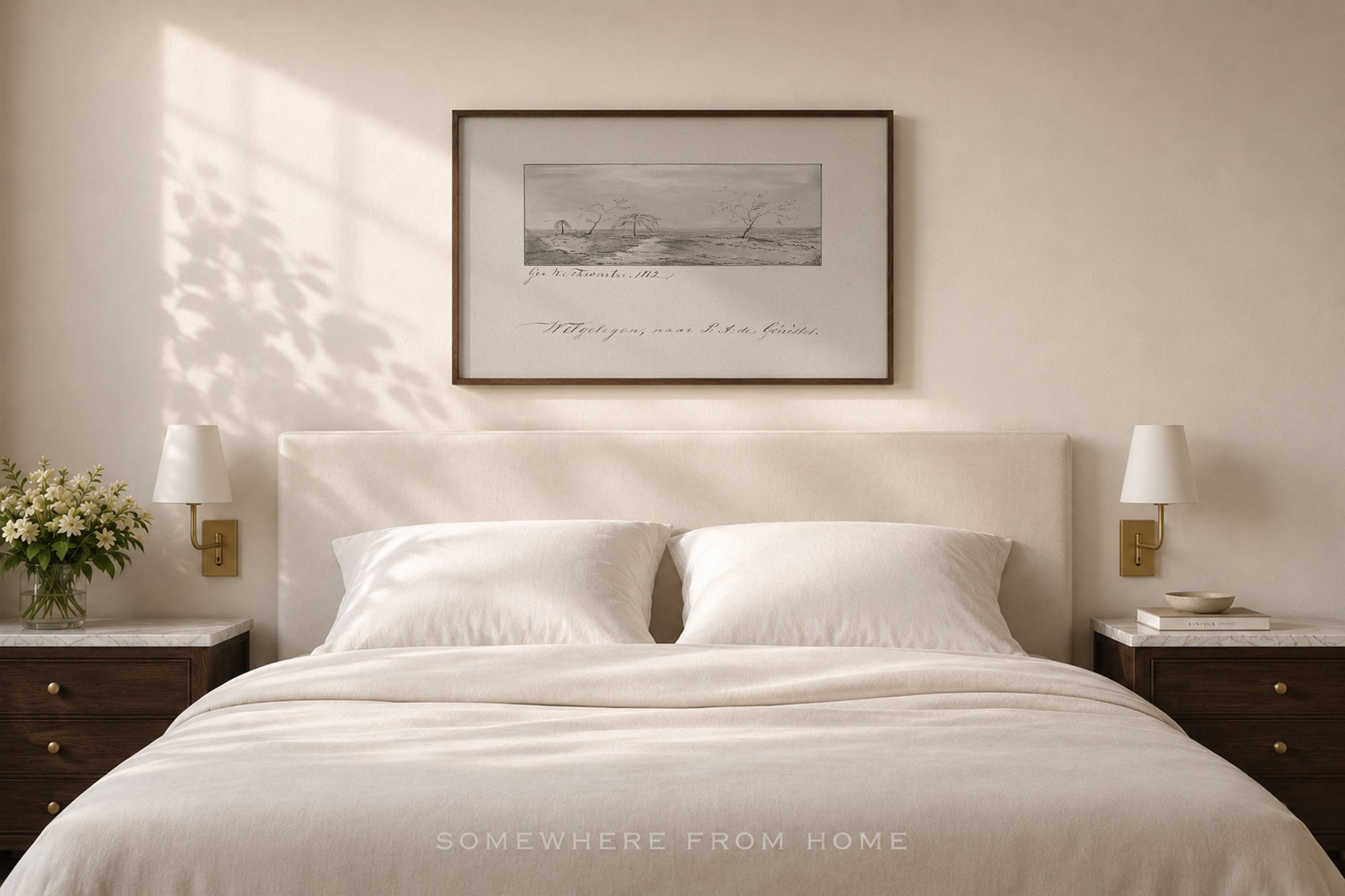 A styled bedroom scene featuring a neatly made bed with white linens and pillows, flanked by matching dark wood nightstands with wall-mounted lamps. Above the bed hangs a framed monochrome landscape print.