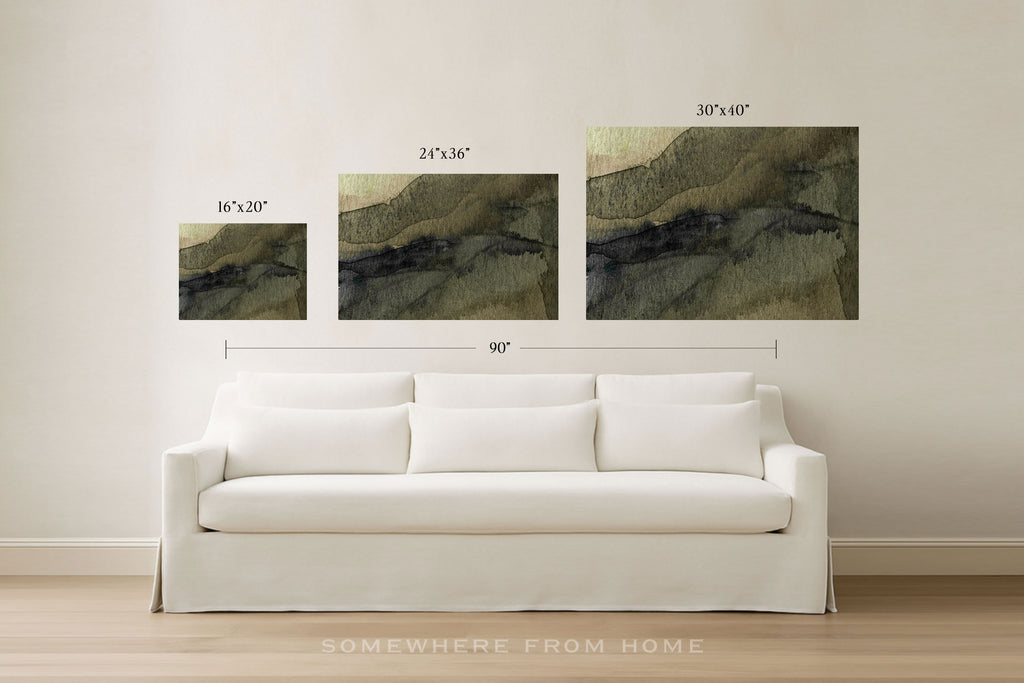 Three framed abstract wall art prints in different sizes are displayed above a white sofa in a bright room. Black dimension lines and text indicate the sizes of each print and the combined width.