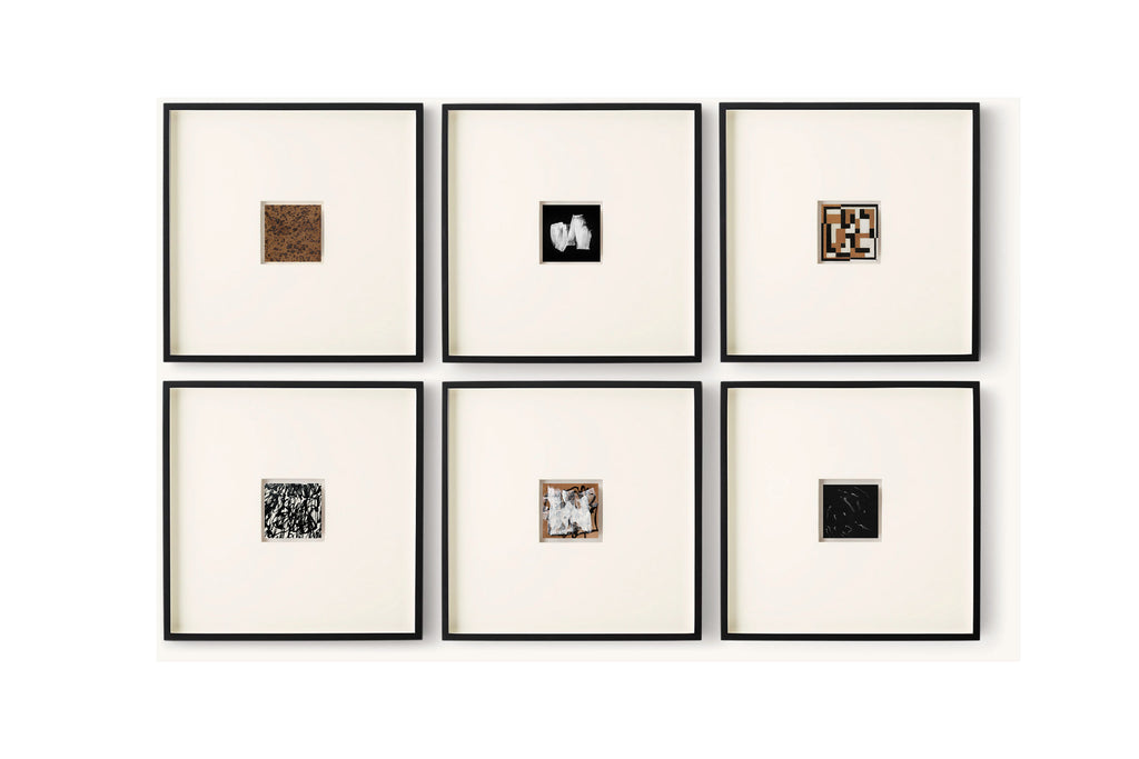Six framed square art pieces arranged in a 2x3 grid on a white wall. Each frame has a black border and a cream mat, displaying small abstract or textured square artworks in different colors and patterns.