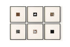 Six framed square art pieces arranged in a 2x3 grid on a white wall. Each frame has a black border and a cream mat, displaying small abstract or textured square artworks in different colors and patterns.