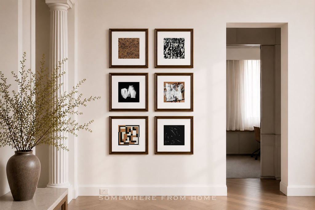 Six framed abstract art prints arranged in a 2x3 grid on a warm beige wall in a styled interior hallway with a white pillar, wooden floor, and a doorway leading to another room.