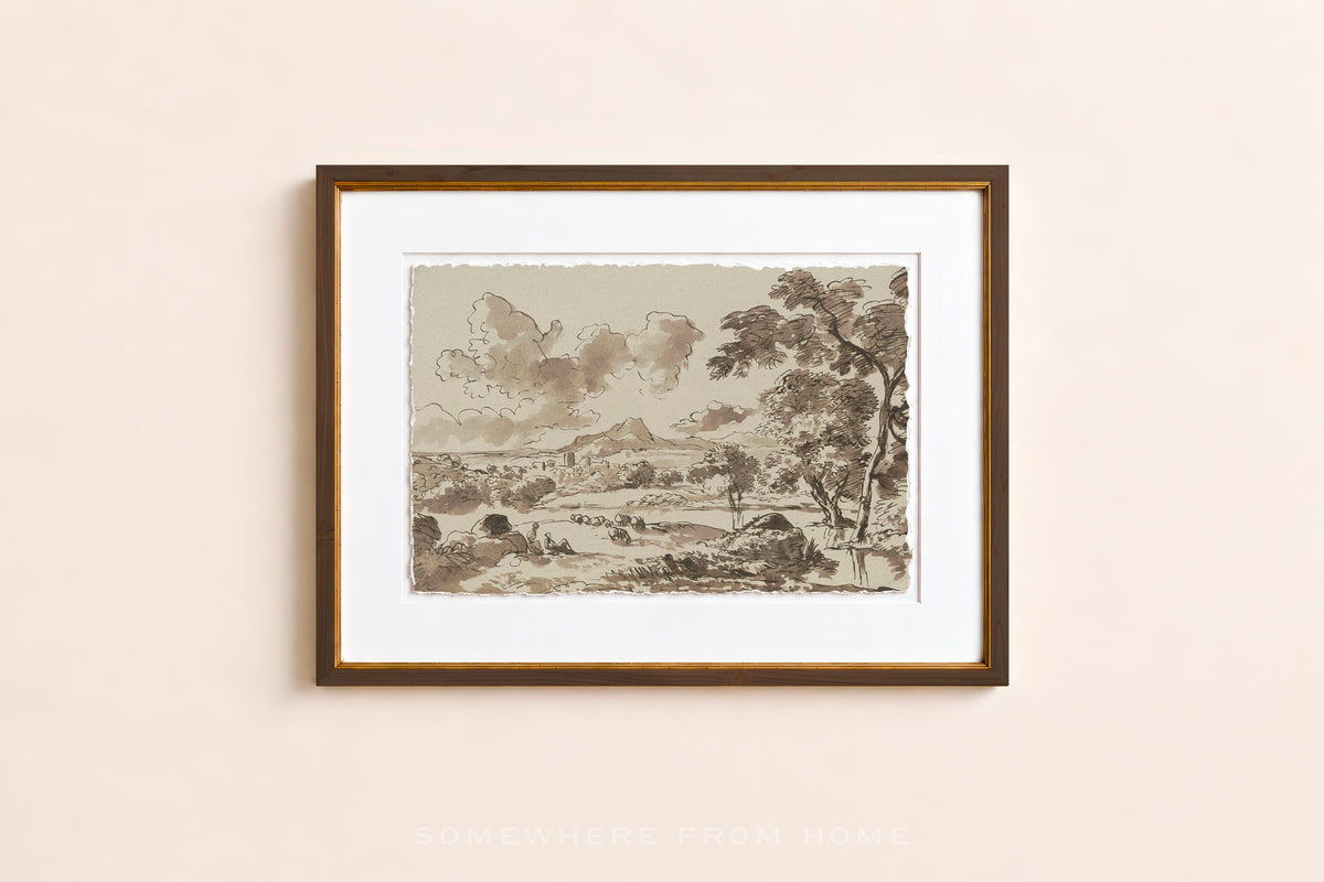 A framed art print featuring a sepia-toned landscape sketch with trees, hills, and clouds, displayed on a light beige wall.